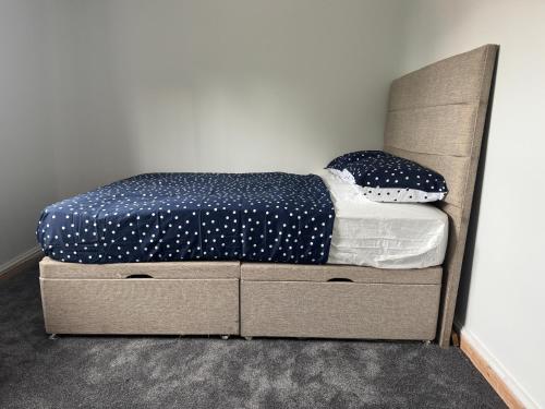 a bedroom with a bed with two drawers at M12 Levenshulme luxury Guesthouse Newly Renovated in Manchester