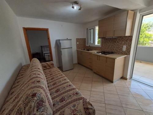 a kitchen with a bed and a refrigerator at Renting rooms in Himare