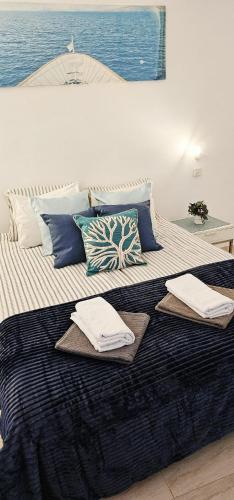 a large bed with two towels on top of it at Sunshine Beach Apartments in Adeje