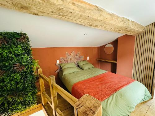 a bedroom with a bed with a wooden headboard at La Maisonnette de Mouragues in Foix