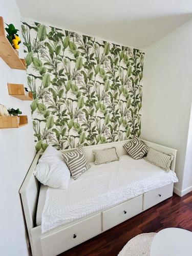 a bed in a room with a wall at Nice studio with a terrace in Levallois-Perret