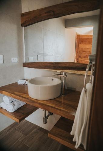 a bathroom with a sink on a wooden counter at Cabañas by 7 Valles in Valle de Guadalupe