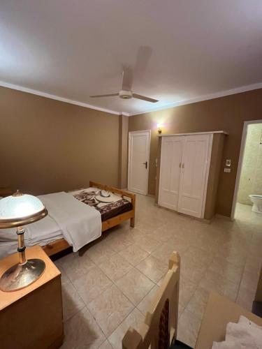a bedroom with a bed and a ceiling fan at RK Hotel in Luxor