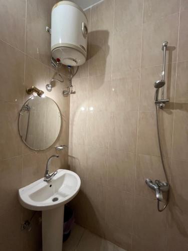 a bathroom with a shower and a sink and a mirror at RK Hotel in Luxor