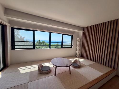 a room with a table and two chairs and a window at LAGUNA OKINAWA Beachfront - Vacation STAY 30553v in Yaka