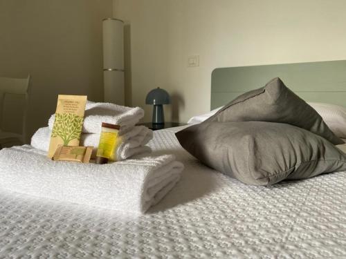 a bed with towels and books on top of it at Antico Borgo sul Mare in Petacciato