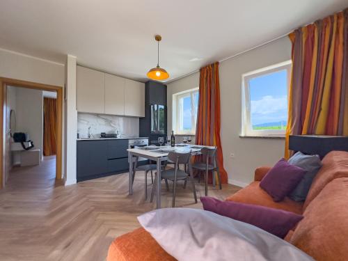 a living room and kitchen with a couch and a table at Cecilia Apartments - stunning sea views and relaxing Mediterranean getaway in Lun