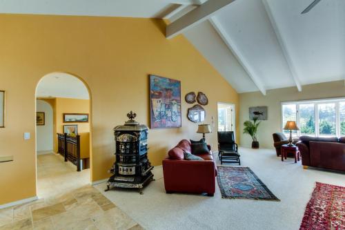 a living room with a couch and a fireplace at Hidden Luxury Beachfront Estate in Yachats