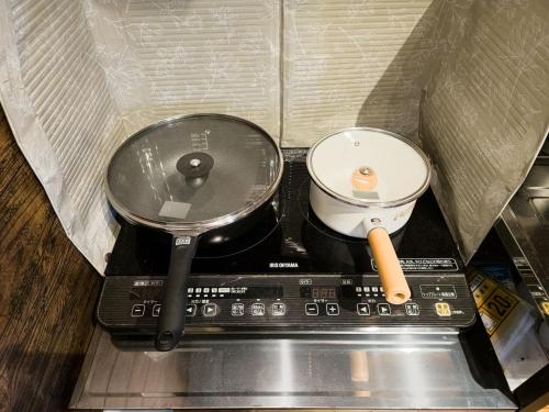 a stove with a pot and a bowl on it at Duplex Ooba - Vacation STAY 33424v in Takahara