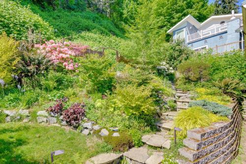 a garden with a stone path and flowers at Waterfront Gem with 2 Patios on Camano Island in Camano