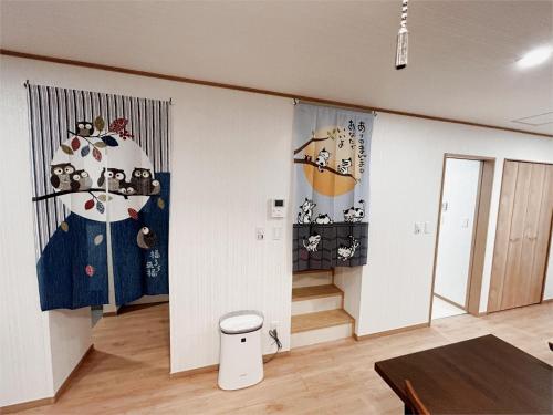 a living room with a table and a wall at The Ritz Okinawa Kise II - Vacation STAY 36742v in Nago