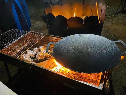 a large pot on top of a grill with donuts at Ancient House World - Vacation STAY 37565v in Koura