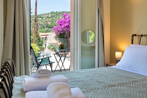 a bedroom with a bed and a large window at Sueño Central Apartments in Gaios