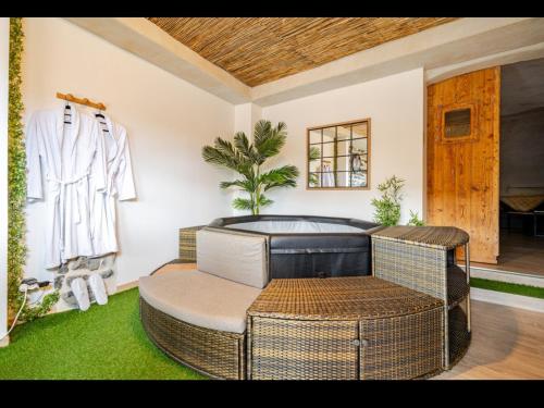 a living room with a chair and a couch at Nuit romantique avec spa privatif in Meilhaud