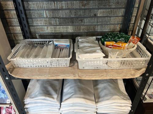 a shelf with three plastic containers on it at Hotel Tetora Hachinohe - Vacation STAY 46446v in Hachinohe