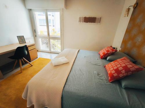 a bedroom with a bed with a desk and a window at Stylish Comfort in Mandelieu in Mandelieu-la-Napoule