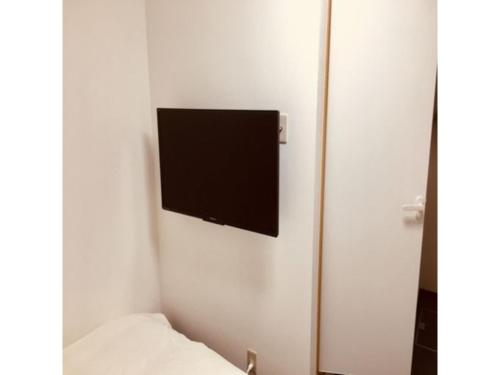 a flat screen tv on a wall in a room at Hotel Tetora Hachinohe - Vacation STAY 46511v in Hachinohe