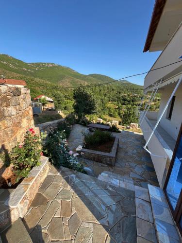 a view of a patio with a hill in the background at Guest House Novaku 