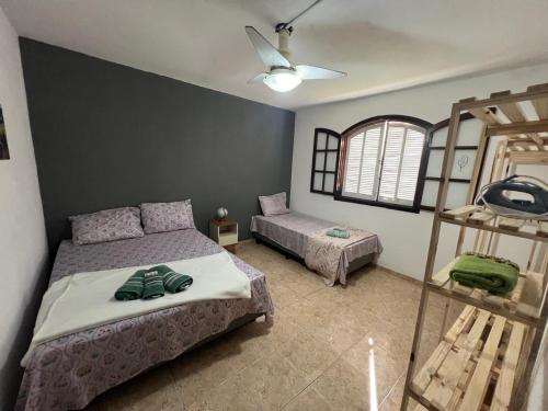 a bedroom with two beds and a ladder at Recanto da Serra in Miguel Pereira