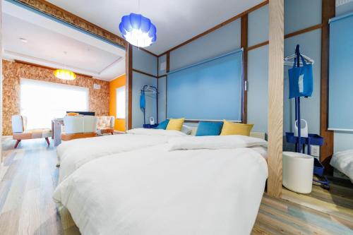 a hotel room with three beds and a large window at Biei Yume Yume House - Vacation STAY 38543v in Biei