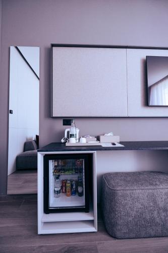 a small refrigerator in a living room with a tv at Vila Infinity-Luxury Rooms in Himare