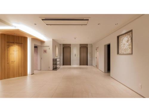 an empty corridor in a building with a painting on the wall at Sun Hotel Fukuyama - Vacation STAY 53489v in Fukuyama