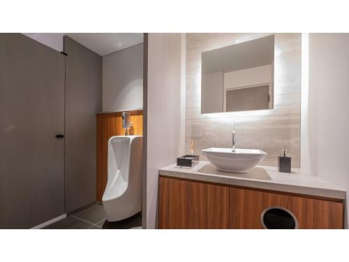 a bathroom with a sink and a urinal at Sun Hotel Fukuyama - Vacation STAY 53476v in Fukuyama