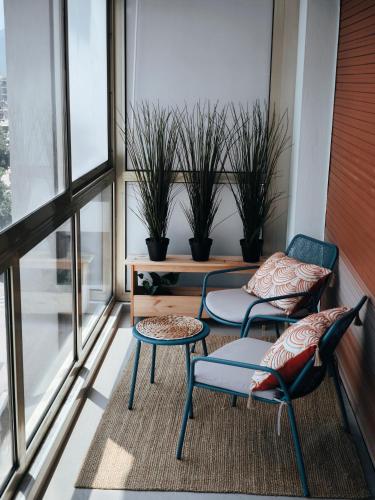 two chairs and a table on a balcony with plants at Stylish Comfort in Mandelieu in Mandelieu-la-Napoule