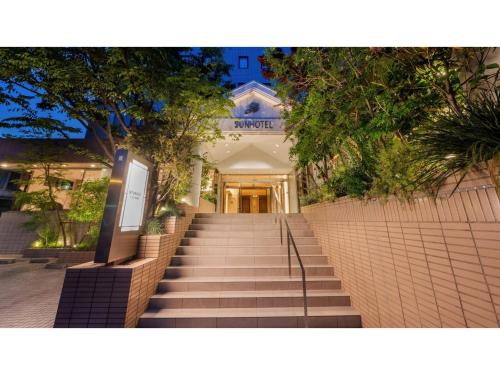 a staircase leading up to a building with trees at Sun Hotel Fukuyama - Vacation STAY 42339v in Fukuyama