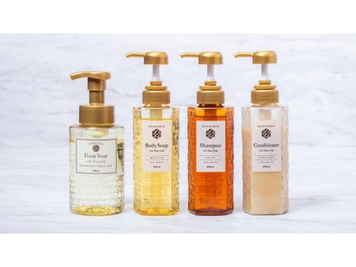 four bottles of essential oils lined up on a shelf at Sun Hotel Fukuyama - Vacation STAY 42339v in Fukuyama