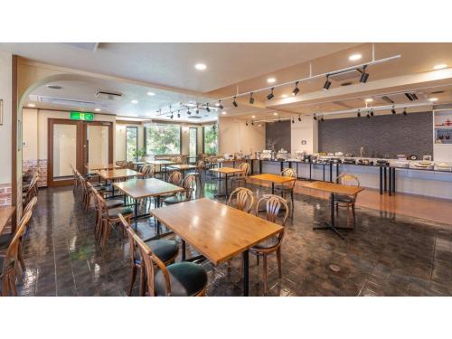 a restaurant with tables and chairs and a bar at Sun Hotel Fukuyama - Vacation STAY 53496v in Fukuyama