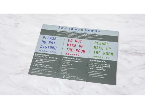 a couple of signs sitting on top of a marble counter at Sun Hotel Fukuyama - Vacation STAY 53496v in Fukuyama