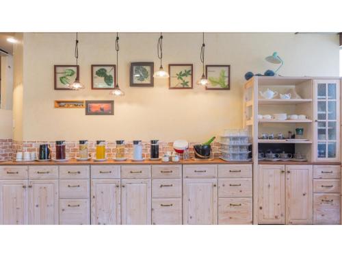 a kitchen with wooden cabinets and a counter top at Sun Hotel Fukuyama - Vacation STAY 53481v in Fukuyama
