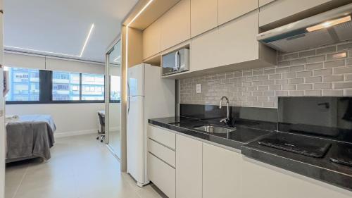 a kitchen with a sink and a counter top at GO Rio Branco by LikeHome in Porto Alegre