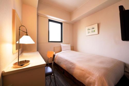 Кровать или кровати в номере Morioka New City Hotel