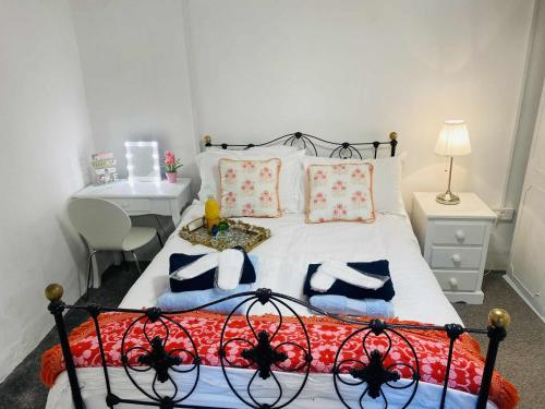 a bedroom with a bed with pillows on it at The Olde Farmhouse 