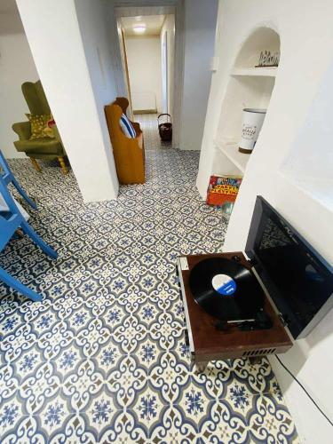 a living room with a tv and a floor at The Olde Farmhouse 