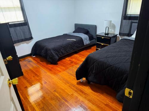 a bedroom with two beds and a wooden floor at Centralized Modern Home in Johnson City in Johnson City