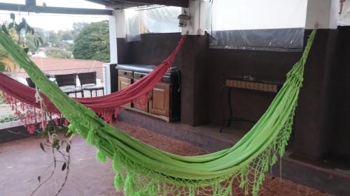 a hammock on the porch of a house at Recanto da Matriz - Águas da Prata in Águas da Prata
