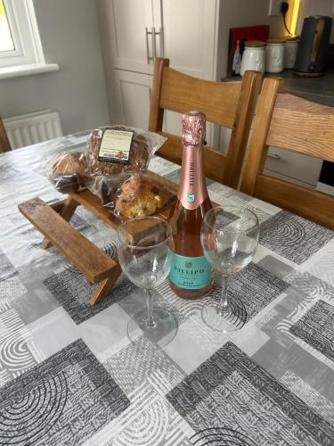 a bottle of wine sitting on a table with two glasses at Carlingford View in Kilkeel