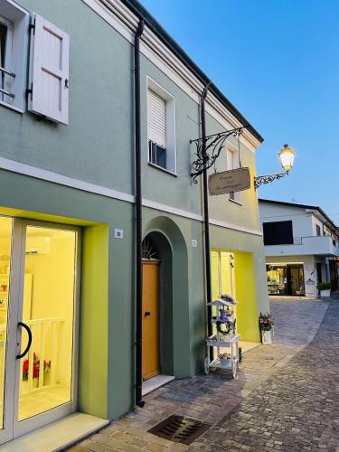 a building with green and yellow on a street at Piccolo Da Vinci 17 in Cesenatico