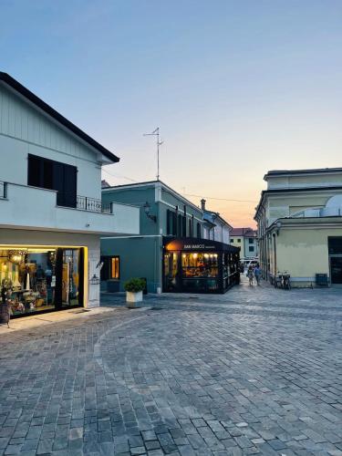a group of buildings on a brick street at Piccolo Da Vinci 17 in Cesenatico