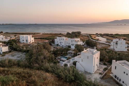an aerial view of white buildings and the ocean at Kuzulu Beach House, Your Private Paradise in Plaka, Naxos in Plaka