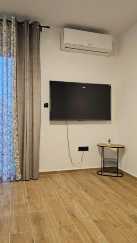 a room with a flat screen tv on a wall at Val Center in Novalja