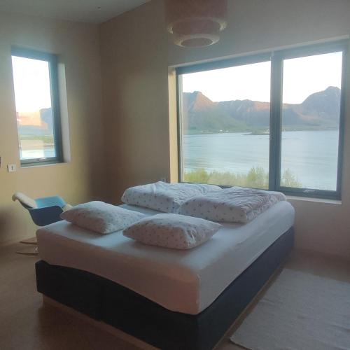 a bedroom with two beds and a large window at Villa by the sea in Vesterålen 