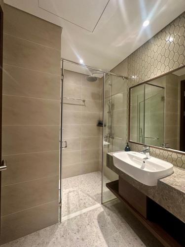 a bathroom with a sink and a shower at Mandala Muine M2012A in Phan Thiet