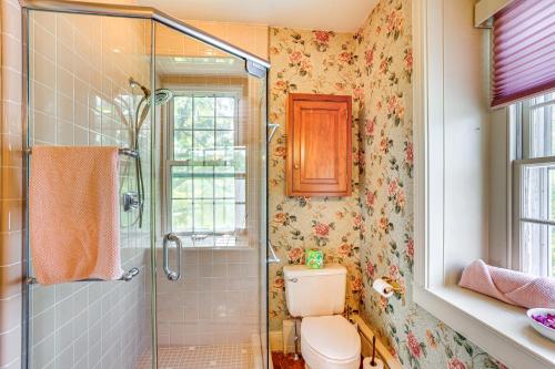 a bathroom with a toilet and a glass shower at 8 Mi to Reading Spacious Farmhouse Retreat! in Birdsboro