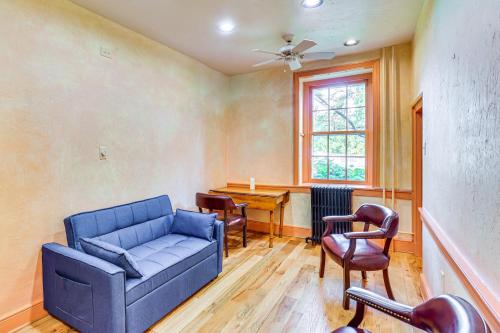 a living room with a blue couch and chairs at 8 Mi to Reading Spacious Farmhouse Retreat! in Birdsboro