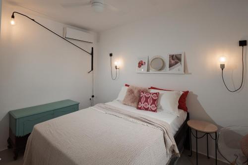 a small bedroom with a bed and two lights at Kuzulu Beach House, Your Private Paradise in Plaka, Naxos in Plaka