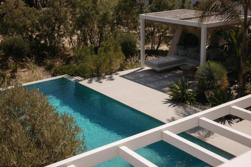 a swimming pool in a garden with a gazebo at Kuzulu Beach House, Your Private Paradise in Plaka, Naxos in Plaka